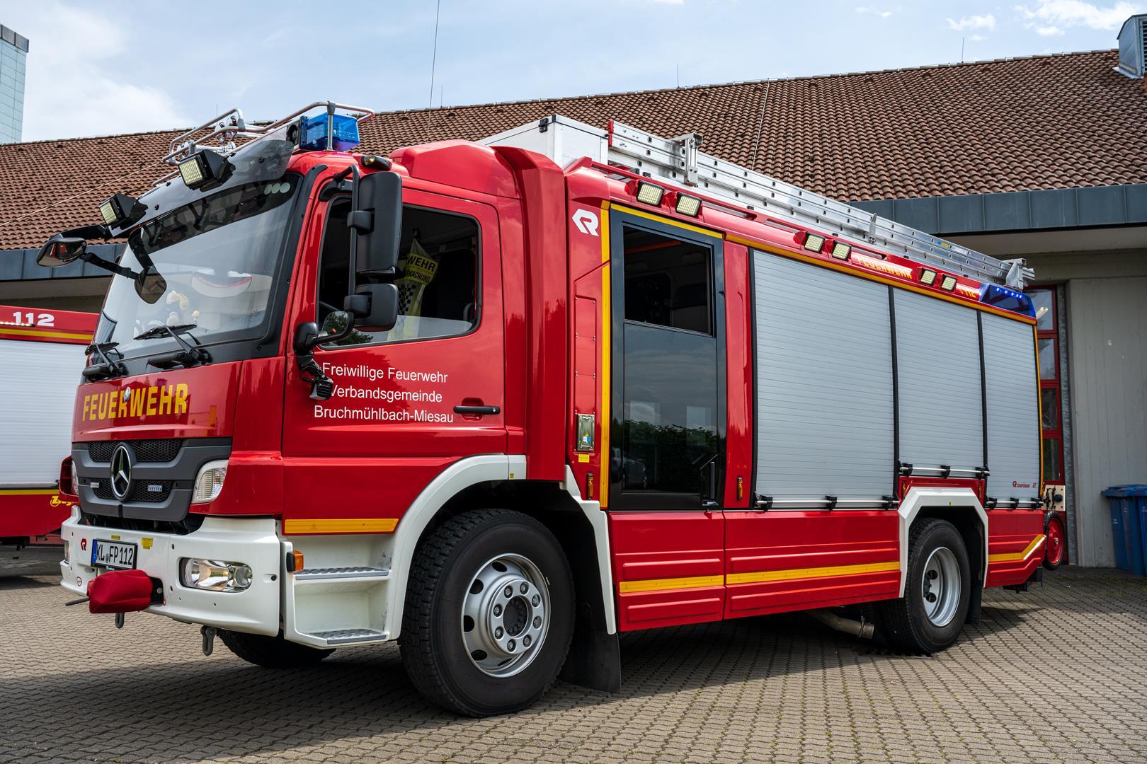 Feuerwehrauto von der Seite vor dem Gerätehaus.